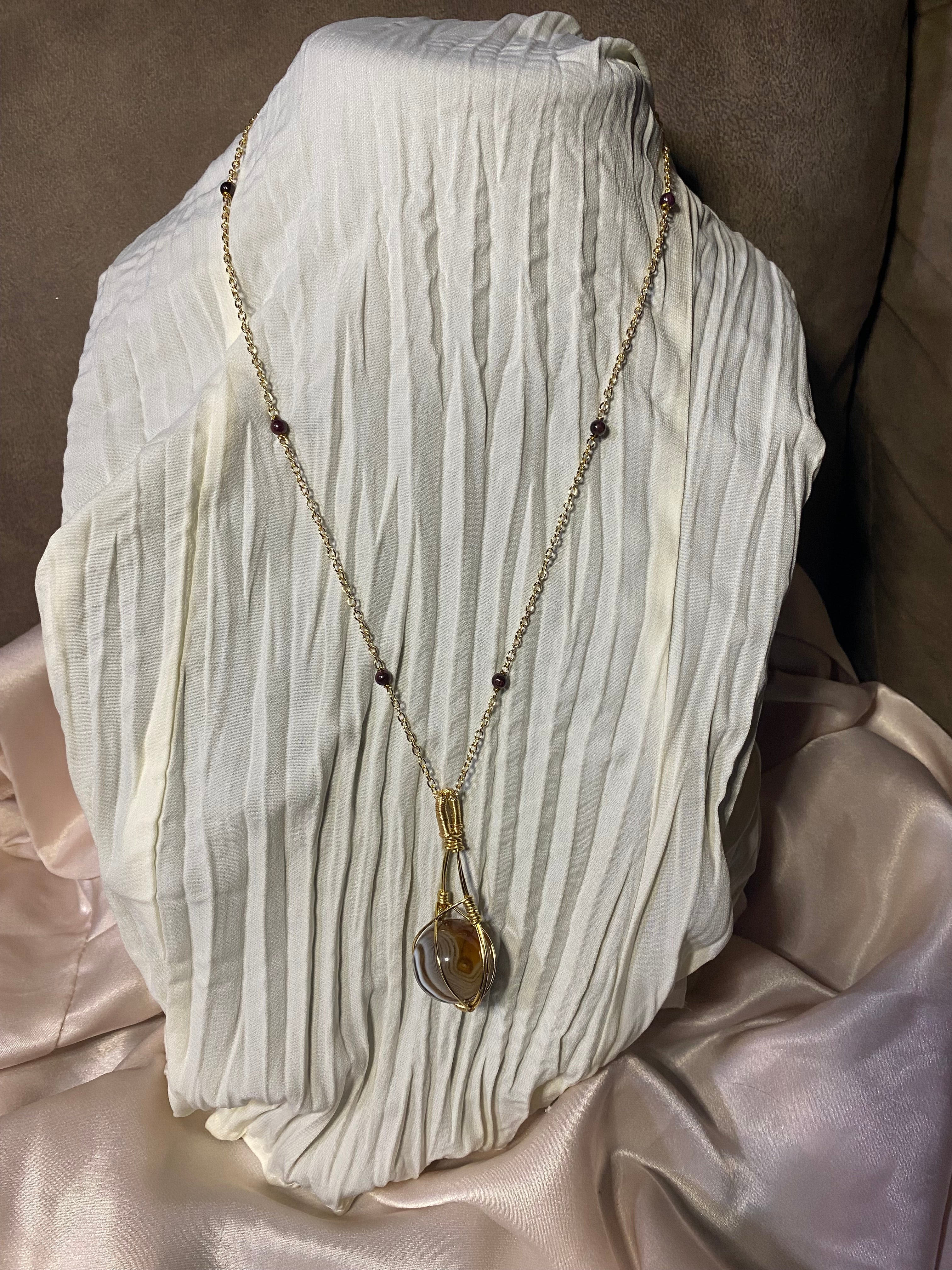 Wire wrapped agate with garnet chain.